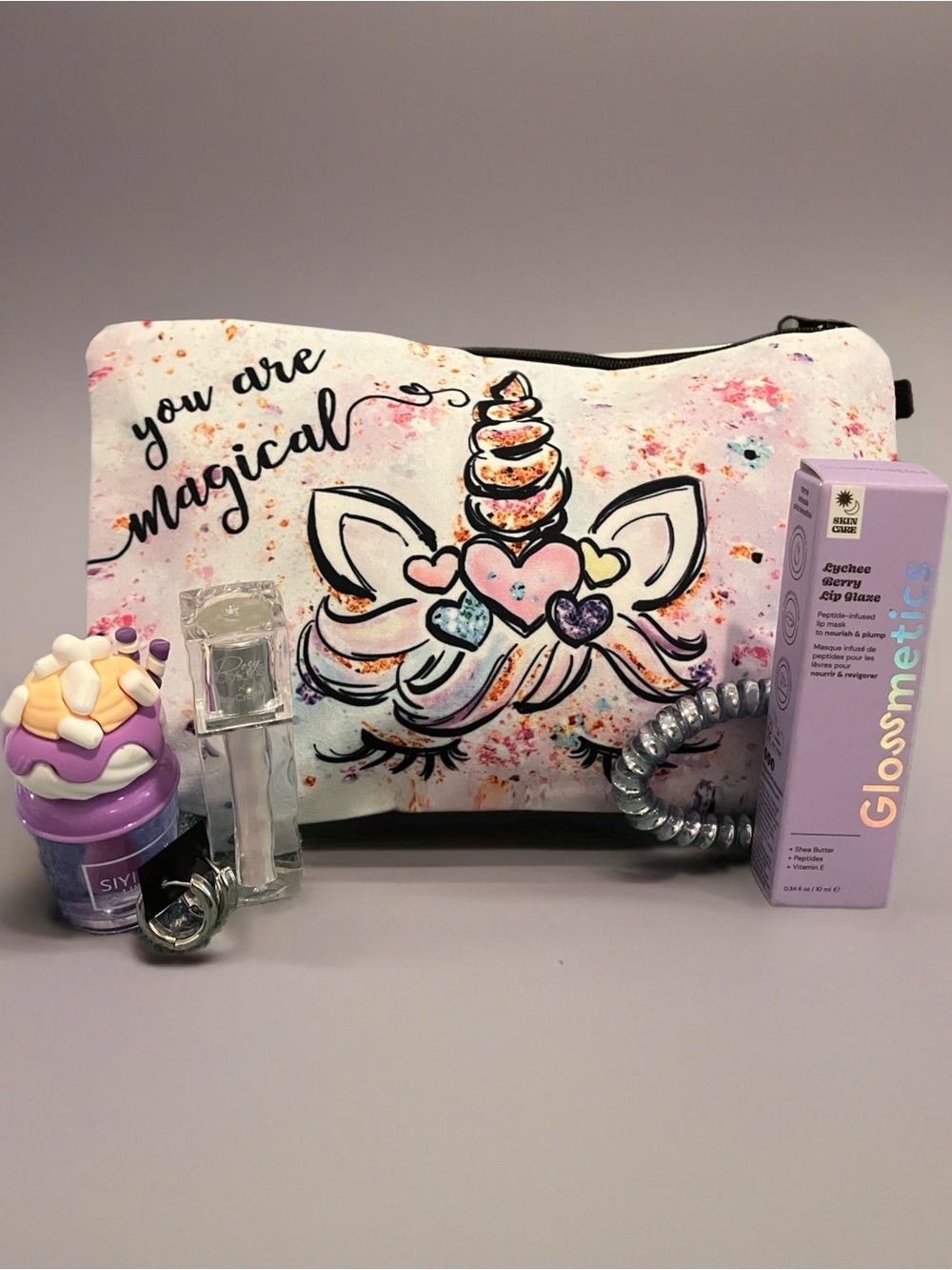 You Are Magical Unicorn Cosmetic Pouch - White & Purple with earrings and makeup